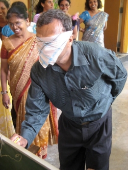 Blindfolded teacher with one hand behind back image